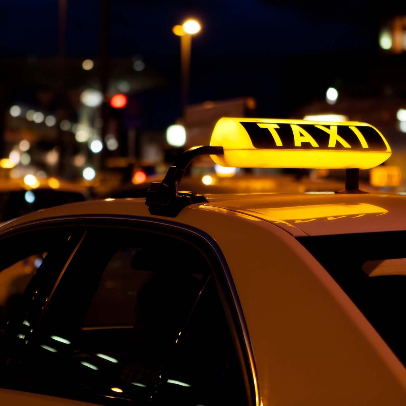 Yellow taxi sign at night